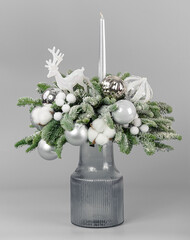 A traditional Christmas floral arrangement of green fir branches and flowers. New Year's decor for the interior