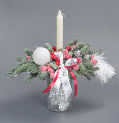 A traditional Christmas floral arrangement of green fir branches and flowers. New Year's decor for the interior