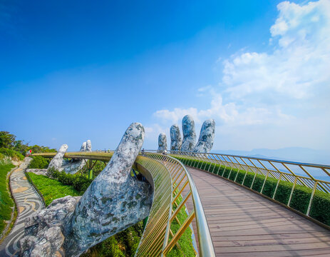 12 15 2024 - Da Nang, Vietnam. Golden Bridge in Ba Na hills, Da Nang, Vietnam on a sunny day. Lifted by two giant concrete hands. Iconic world famous bridge in the mountains