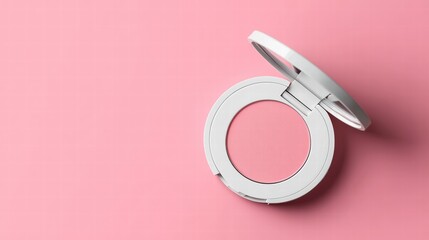 Luxury compact makeup powder in a white round case with a mirror, isolated on a pink background. Top view.