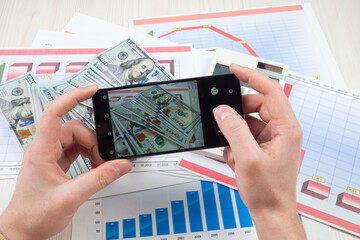 Hands counting dollars on the table. The concept of financial success