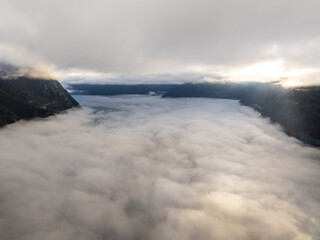 clouds in the mountains, over the fjord.