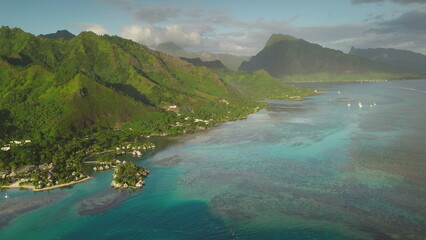 Aerial drone beauty of Moorea tropical island in French Polynesia, showcasing turquoise lagoon, green volcanic mountains, vibrant coral reef. Popular travel destination, remote wild paradise
