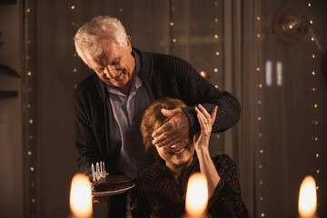 Elderly Man Surprising Woman with Birthday Cake