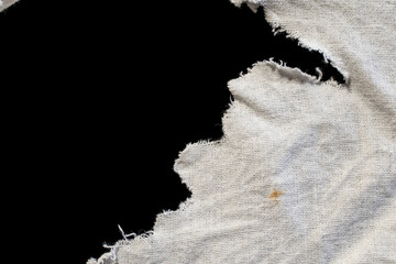 torn old white rag with holes on a black background