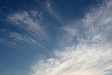 Blue sky and clouds. Cloudy sky landscape, silver cirrus clouds background, afternoon time. Atmosheric phenomenom, meteorology. White transparent  clouds, air, sun light in the high.