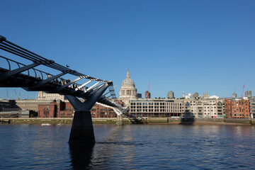 London's iconic Millennium Bridge leading to Saint Paul's Cathedral across the Thames river