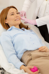 Fototapeta premium Revitalizing facial rejuvenation therapy session with dermal filler application at a serene clinic