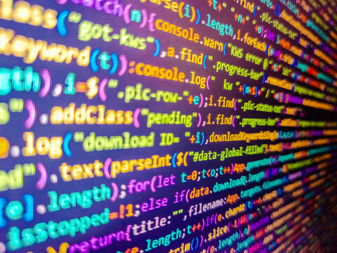 Compressed javascript code on computer screen. Web dewelopment. The colorful code on screen. Abstract screen of web developer. Binary code background. Template of website, selective focus.