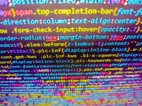 Bright colorful knitted pattern closeup look. Jquery code background. Structured sql code on monitor. Developer screen with colored website programming code. Background of program code.