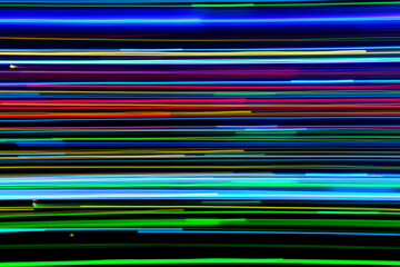 A long exposure photograph. Light painting photography, vibrant fairy lights against a black background