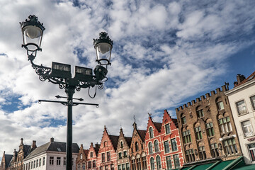 Street lamp in the central square  and the houses with colorful facades. Bruges, Belgium