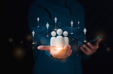 Customer Relationship Management, Businessman holds virtual icons representing potential candidates, Data exchanges development. customer service, social media. digital marketing online.