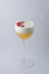 A delightful drink served in a wine glass adorned with foam on top