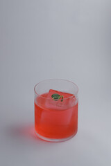 A refreshing glass filled with vibrant red liquid and ice cubes