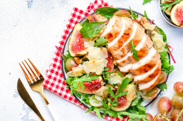 Green salad with tuna, avocado, cucumber, onion and lettuce. White background, top view