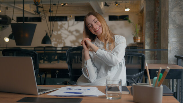 Happy excited Caucasian woman worker business female employer designer girl businesswoman celebrate good result spinning whirl on office chair dancing thumbs up financial success complete work smile