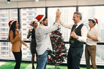 Group of people celebrating Christmas and New Year party in the office Senior manager joining and having fun and good time with his colleagues Festive celebration and happiness lifestyle