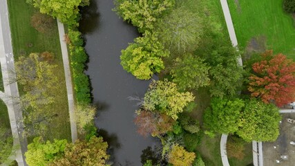 Aerial drone footage of college campus on a cloudy fall day in October in East Lansing Michigan near the red cedar river. College dorms, apartments visible. Beautiful autumn colors everywhere
