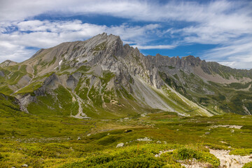 Fototapeta premium Alps scenic landscape on Tour du Montblanc. Rocky and snow summit peaks of the Alps on the trekking route TMB around Mont Blanc in Chamonix and Courmayeur. Alpine scene with mountains and lakes 