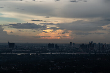 Fototapeta premium view of Bangkok city and beautiful clouds in sky background with the Chao Phraya River before sunset. use it as your wallpaper, poster and Space for text, Selective focus.