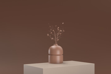 A vase with a tree inside it sits on a brown surface