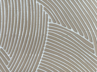 Close up of random curved fluted pattern made with porcelain ceramic tiles in abstract curves. Rough uneven surfaces of porcelain ceramic tiles seamless background texture. © TMR Studio
