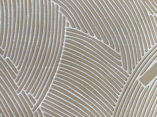 Close up of random curved fluted pattern made with porcelain ceramic tiles in abstract curves. Rough uneven surfaces of porcelain ceramic tiles seamless background texture. © TMR Studio