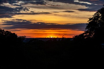 Dramatic sunrise with intense natural orange lights and idyllic dramatic scenery