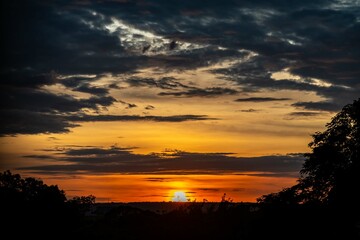 Fototapeta premium Dramatic sunrise with intense natural orange lights and idyllic dramatic scenery