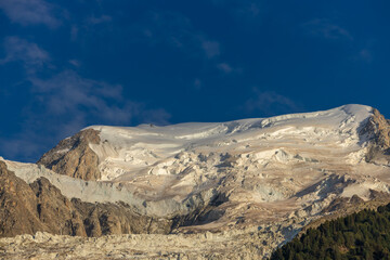Alps scenic landscape on Tour du Montblanc. Rocky and snow summit peaks of the Alps on the trekking route TMB around Mont Blanc in Chamonix and Courmayeur. Alpine scene with mountains and lakes 