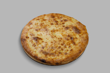 A delicious pizza topped with plenty of cheese is resting on a gray surface