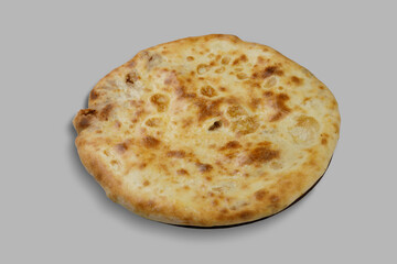 A delicious pizza is sitting on a smooth gray surface nearby
