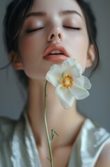 Beautiful Woman Holding a Flower Between Her Lips – High-Quality Portrait Photo