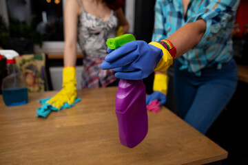 Engaging in a Cleaning Moment with Colorful Supplies and Focused, Determined Action