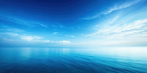 Obraz premium A serene and tranquil expanse of blue water meeting a sky filled with wispy clouds.