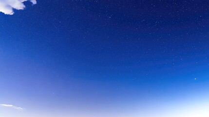 Twinkling Starry Night Sky with White Clouds and Blue Gradient Background, Capturing Vast Universe and Starlight, High Definition Long Exposure Photography Using Wide-Angle Lens, Low Angle Night View
