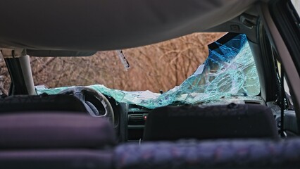 Interior of Car Wrecked in Road Accident with Shattered Glass Windshield
