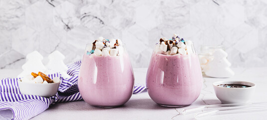 Fresh berry yogurt with marshmallows and icing in glasses on table web banner