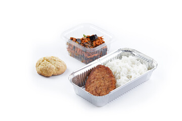 close up white background disposable plastic and foil tableware airplane food snack steamed rice with chicken cutlet vegetable carrot salad white bun dietary program