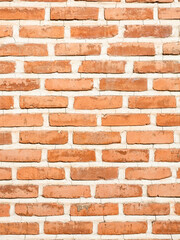 outdoor orange brick wall with seams on sunny day