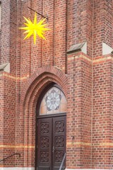 Moravian star hanging on a brick church facade