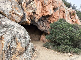 entrance to a cave in a rock on the island of Sardinia