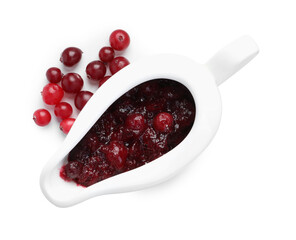 Tasty cranberry sauce in gravy boat and berries isolated on white, top view