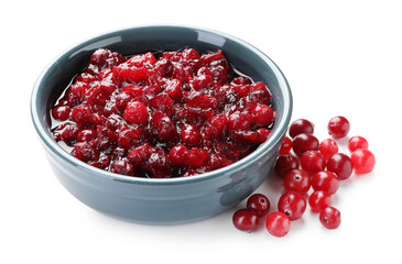 Tasty cranberry sauce in bowl and berries isolated on white