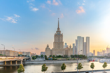 Obraz premium High-rise stalinist building near river at summer sunset in Moscow, Russia. Historic name is Hotel Ukraine.