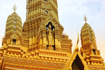 Bangkok, Thailand on 23 July 2023. Ornate Golden Pagoda Detail Against a Cloudy Sky