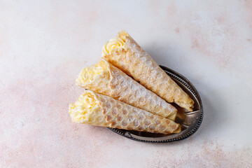 Homemade nut shaped russian soviet cookies and wafer rolls with pastry cream.
