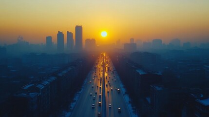 Fototapeta premium Sunset over city skyline with busy roadway reflecting golden light