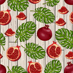 Palm leaves and pomegranates.Vector pattern with red pomegranates and palm leaves on a wooden background.